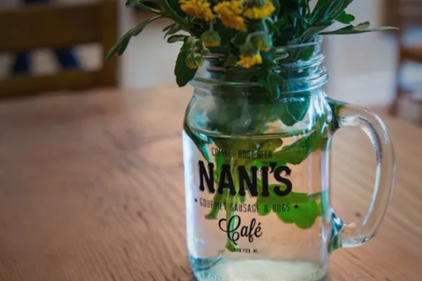 Nani’s Cafe mug with the cafe’s logo.
